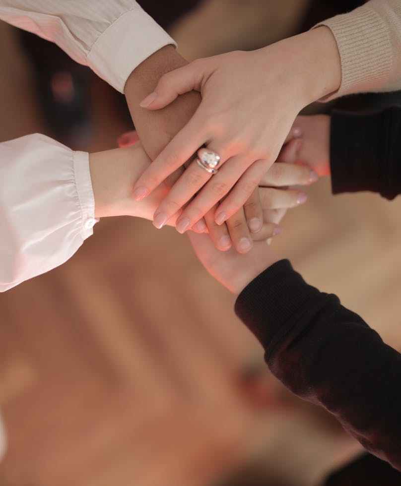 crop friends stacking hands together