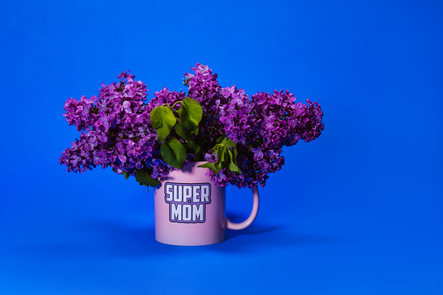 a pink mug with lilac flowers