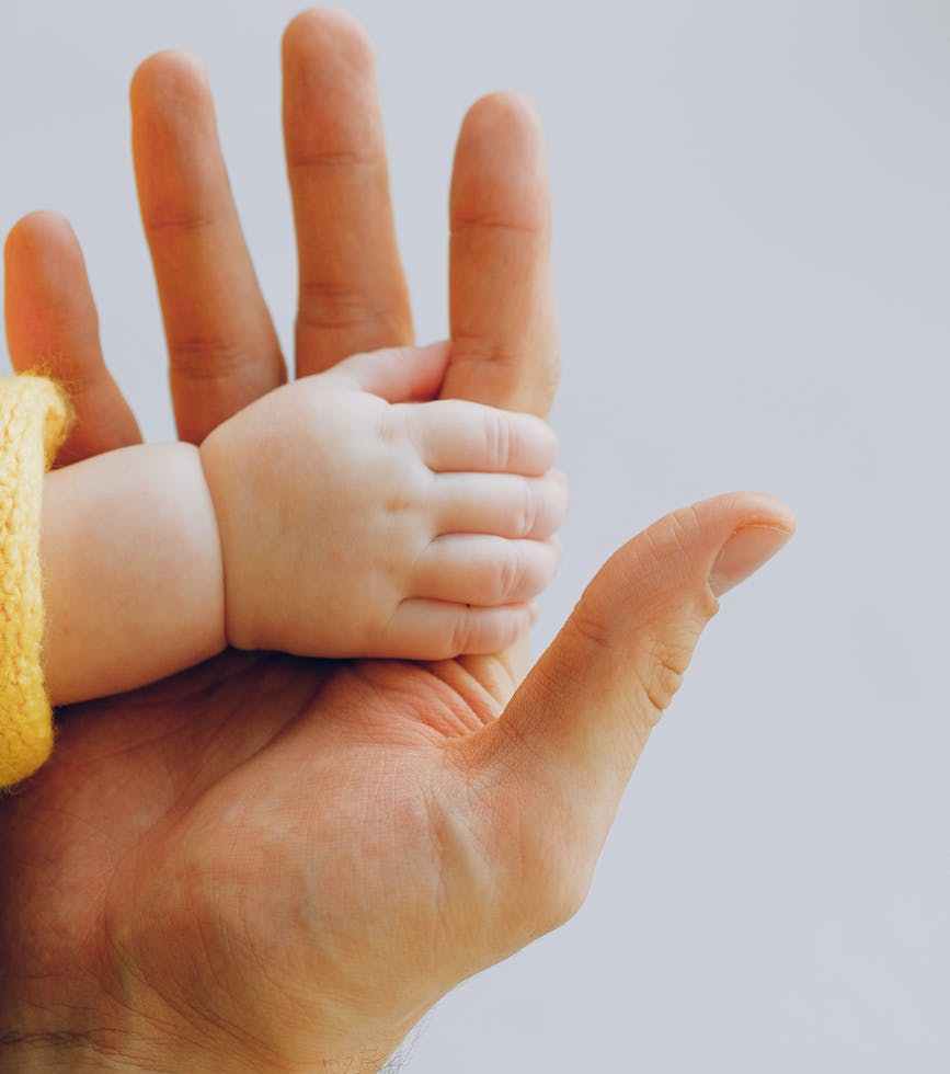 person holding babys hand