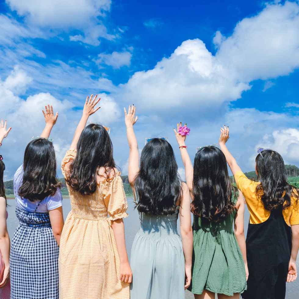 women standing near river