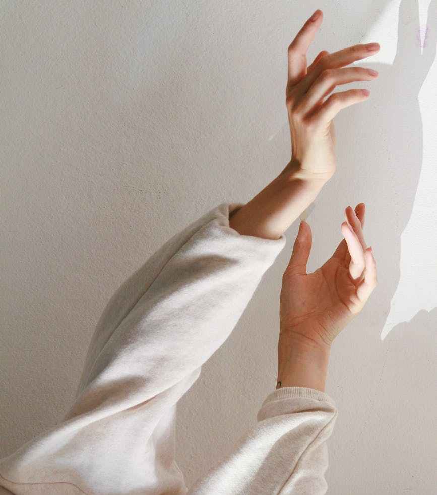 person wearing white long sleeved top