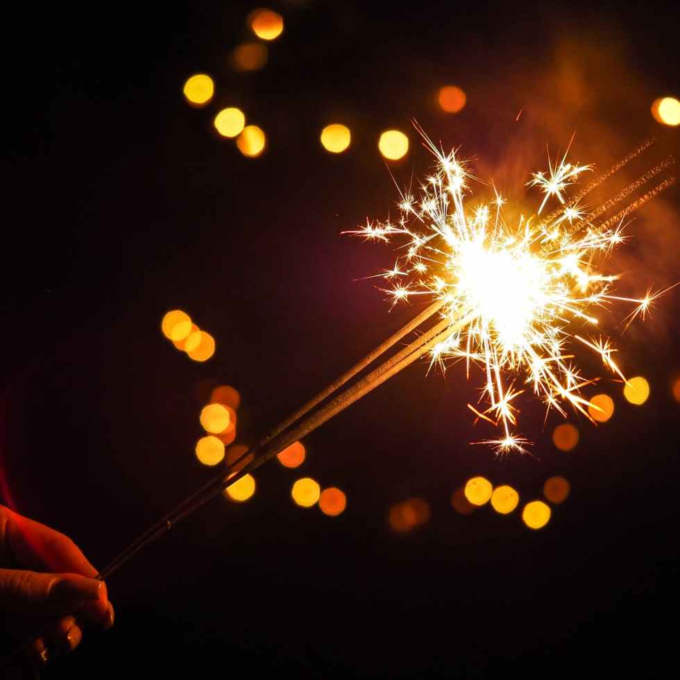 person holding lighted firecracker
